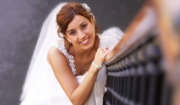 Bride poses for their wedding photographer on a ladder in San Sebastian, Guipuzcoa, Basque Country